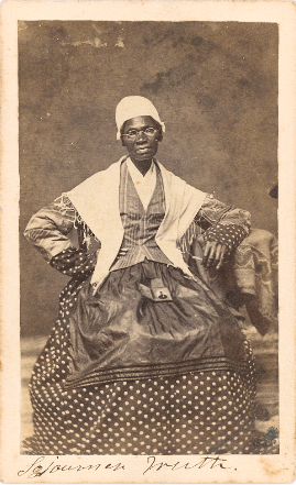 Sojourner Truth seated with photograph of her grandson, James Caldwell of Co. H, 54th Massachusetts Infantry Regiment, on her lap